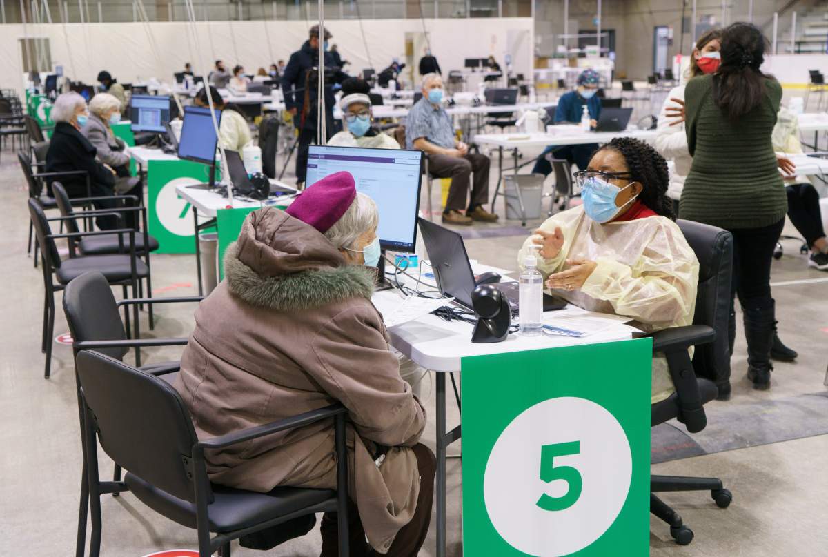 Seniors register at a COVID-19 vaccination clinic in a hockey arena in Montreal, on Wednesday, March 10, 2021.