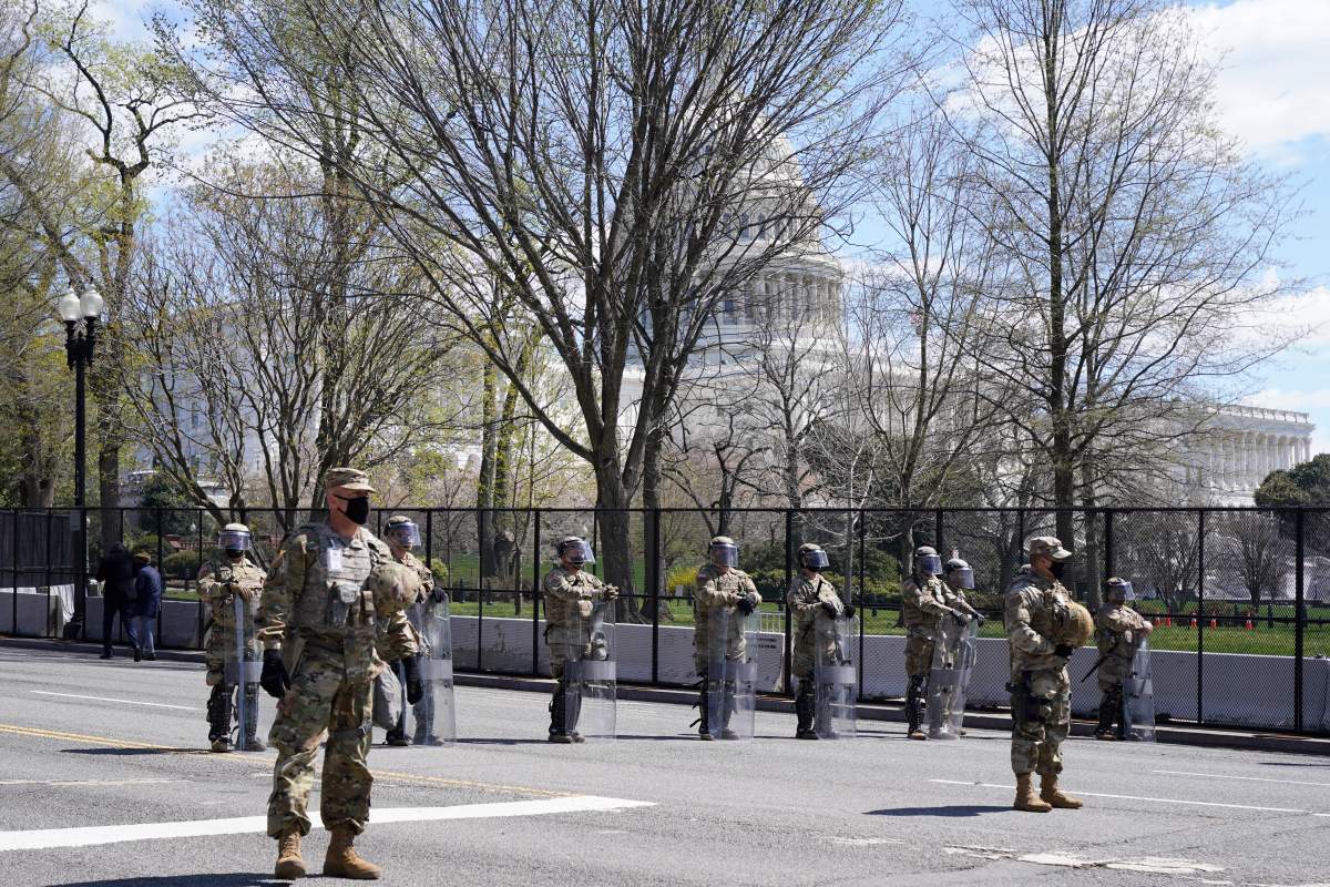 National Guard troops stand guard after a car that crashed into a barrier on Capitol Hill in Washington, Friday, April 2, 2021. (AP Photo/Jacquelyn Martin)