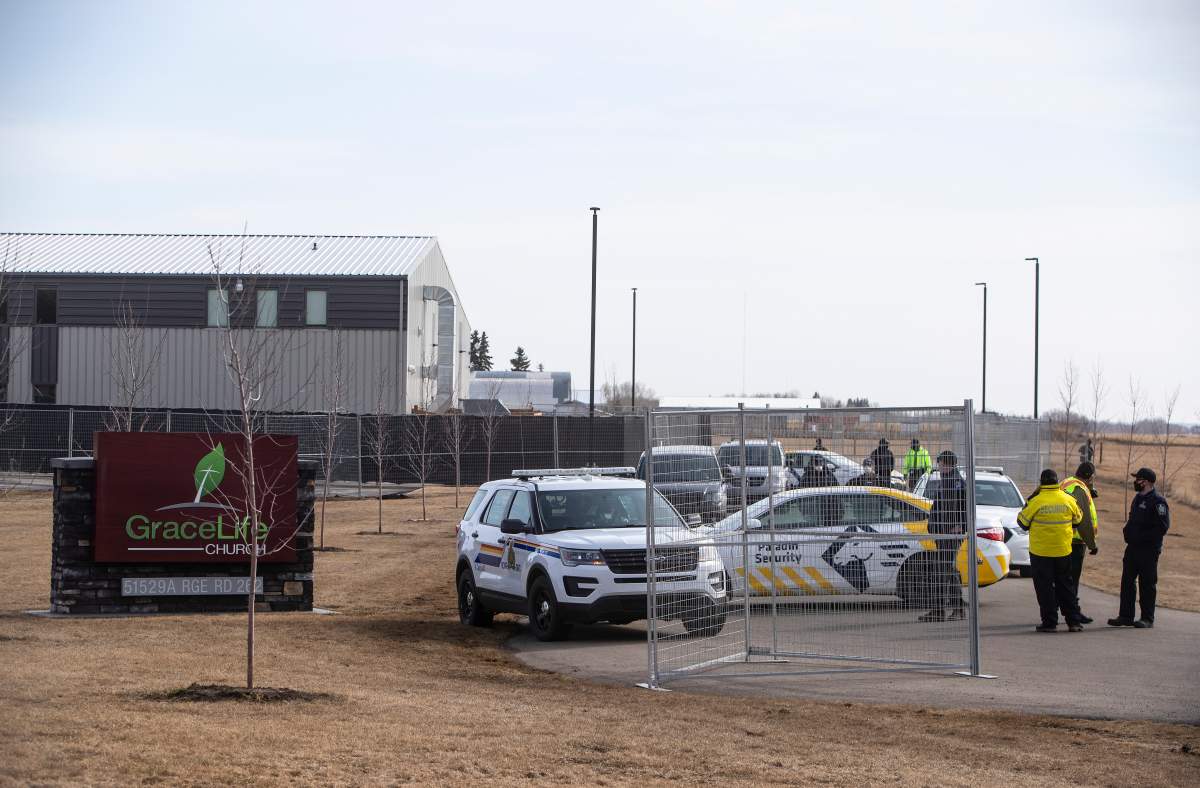 Security and police block the entrance to GraceLife Church as a fence goes up around it near Edmonton on Wednesday April 7, 2021.