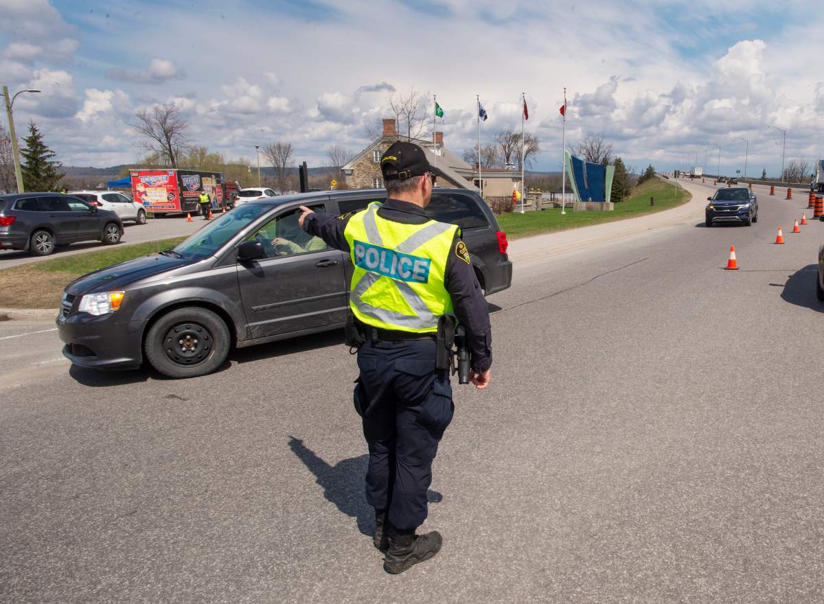 Ontario Provincial Police check travellers entering Ontario from Quebec as new COVID-19 measures take effect Monday, April 19, 2021 in Hawkesbury, Ontario. 