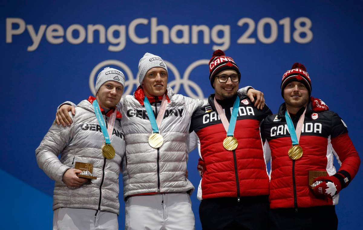 Gold medalists in the two-man bobsled from left, Francesco Friedrich and Thorsten Margis, of Germany, and Alexander Kopacz and Justin Kripps, of Canada, celebrate during their medals ceremony at the 2018 Winter Olympics in Pyeongchang, South Korea, Tuesday, Feb. 20, 2018.