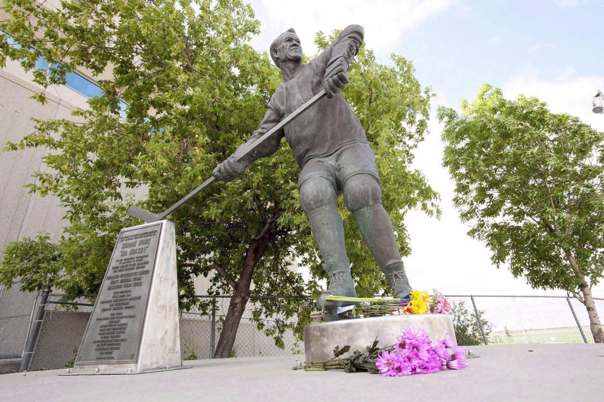 Flowers are placed at a statue of Gordie Howe at SaskTel Centre in Saskatoon after he passed away on June 10, 2016.