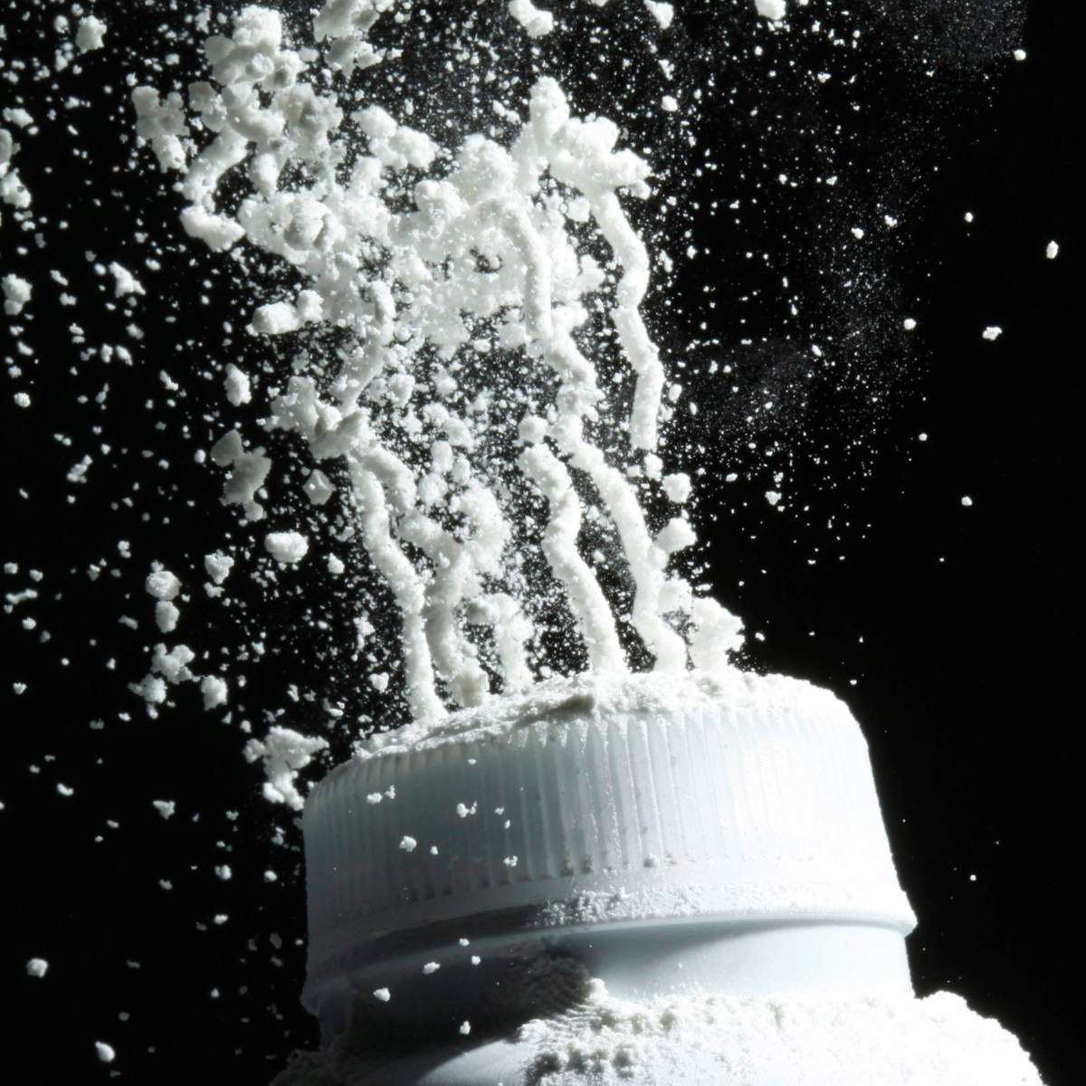 FILE - In this April 19, 2010, file photo, baby powder is squeezed from its bottle in Philadelphia. In a study released on Tuesday, Jan. 7, 2020, U.S. government researchers found no evidence linking baby powder with ovarian cancer in the largest-ever analysis of an issue that has prompted thousands of lawsuits and a recent product recall. (AP Photo/Matt Rourke, File).