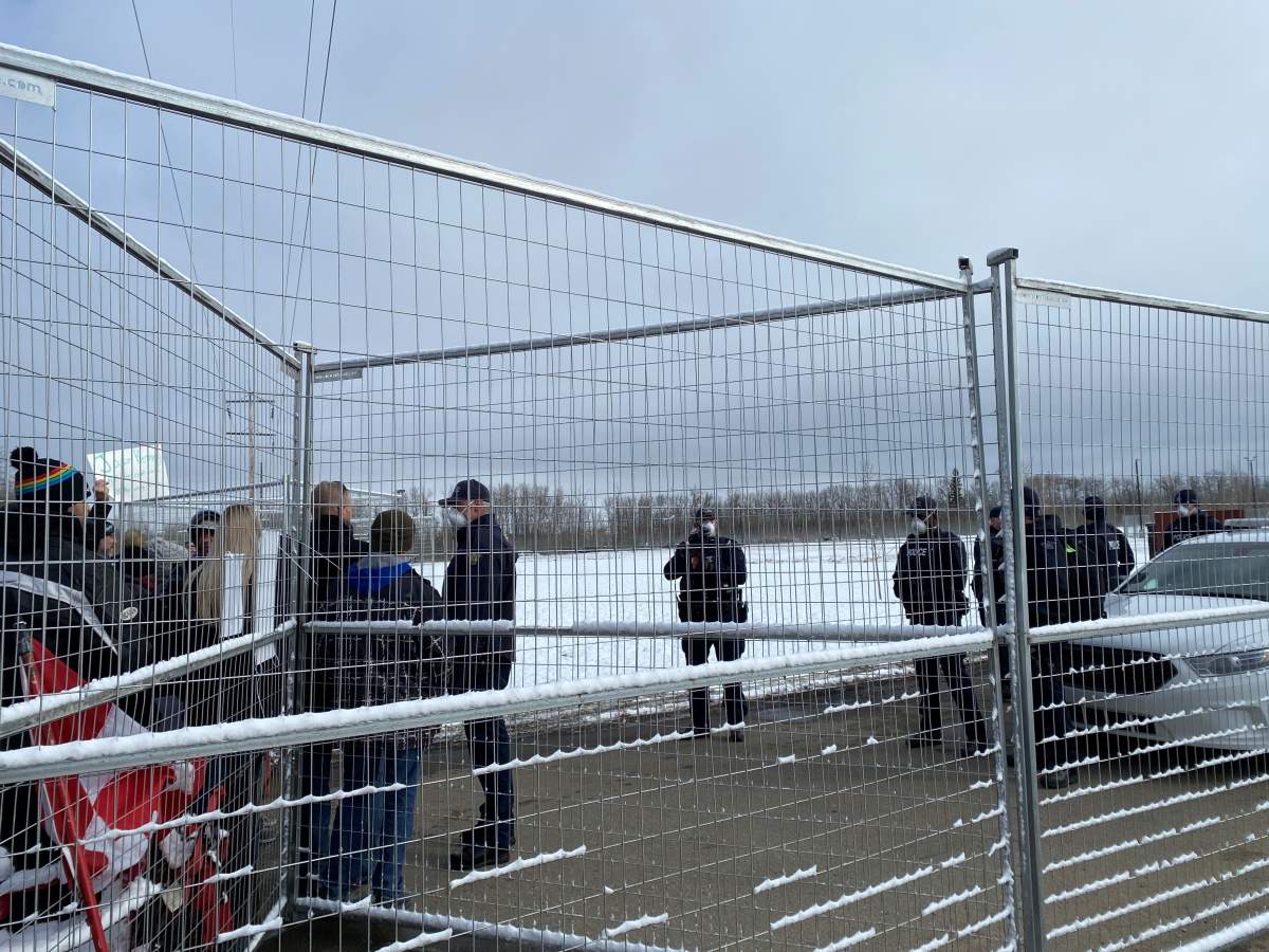 RCMP officers stand outside GraceLife Church as members of a convoy arrive, Sunday, April 11, 2021.