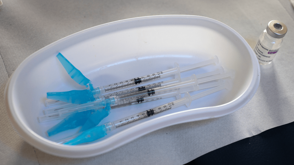 Syringes and a vial of AstraZeneca vaccine against COVID-19 sit on a general practitioners' table during a vaccination campaign Wednesday, April 14, 2021. 
