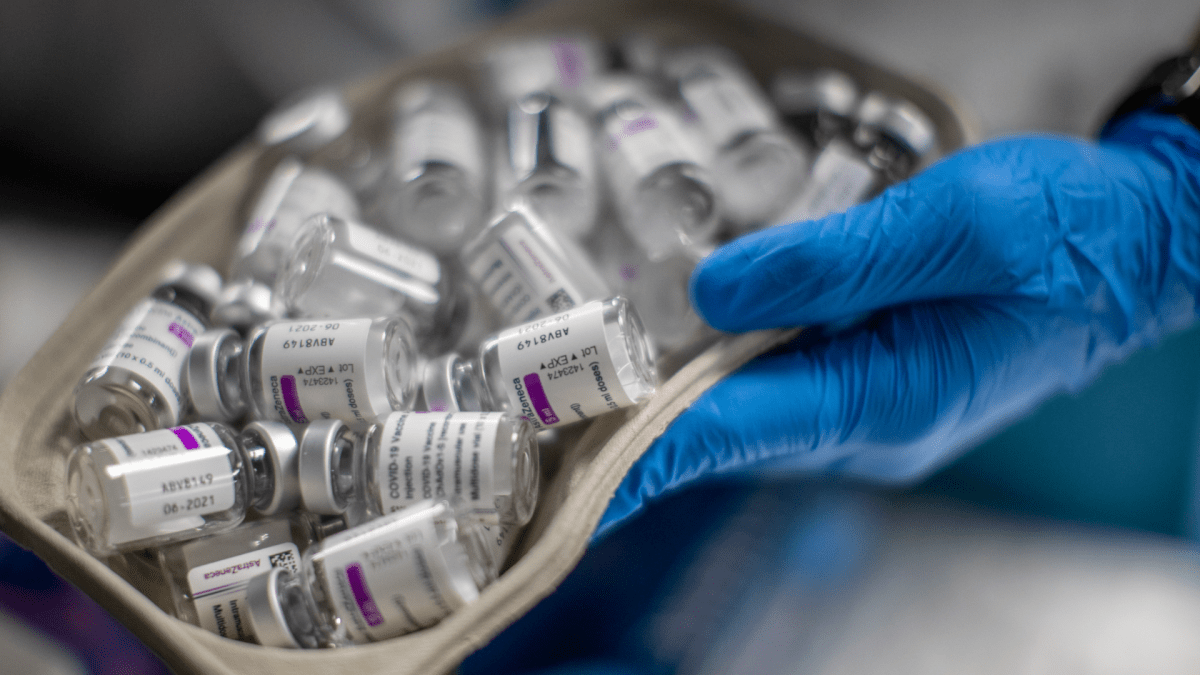 A nurse holds vials of AstraZeneca vaccine against COVID-19.(AP Photo/Manu Fernandez).