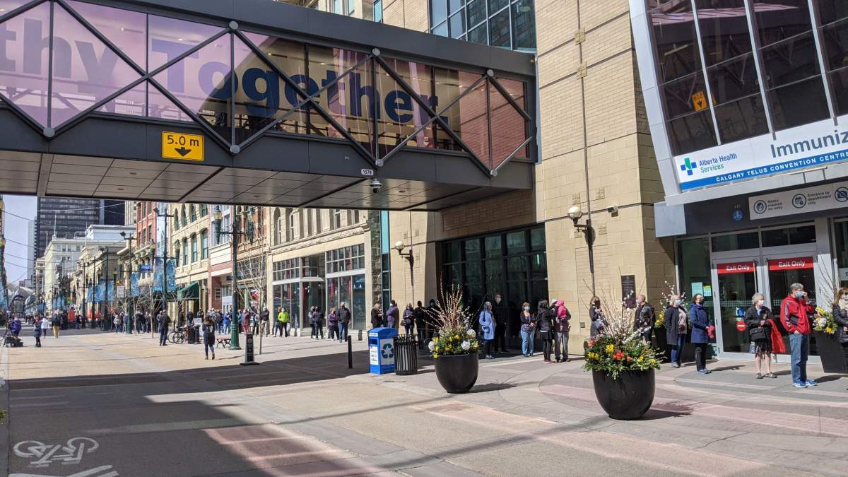 The COVID-19 vaccine site at the Telus Convention Centre in Calgary lined up outside on the first day it opened Monday, April 12, 2021.