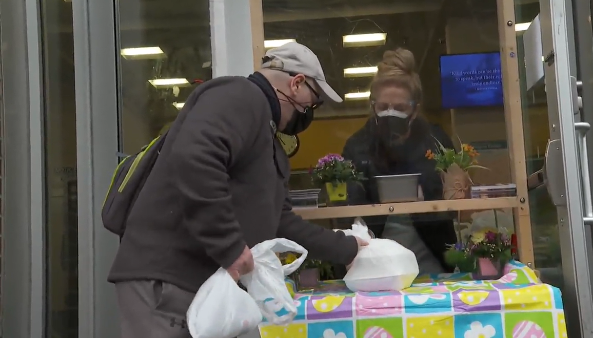 Staff at the Union Gospel Mission hand out Easter meals on Saturday. 