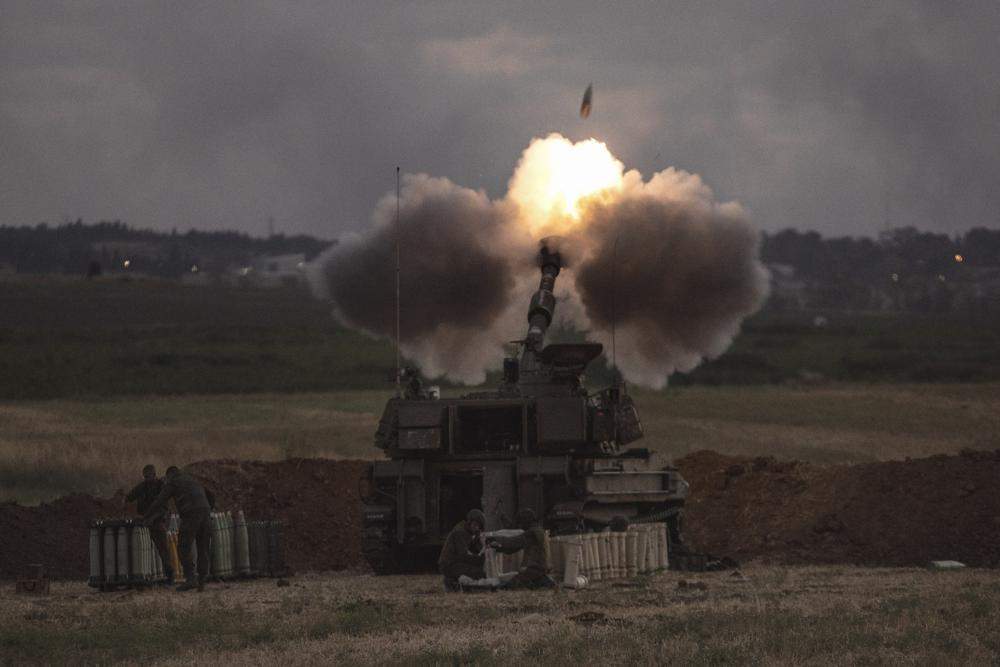 An Israeli artillery unit fires toward targets in the Gaza Strip, at the Israeli Gaza border, Monday, May 17, 2021.