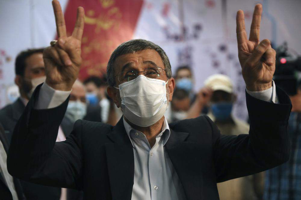 Former President Mahmoud Ahmadinejad flashes victory sign while registering his name as a candidate for the June 18, presidential elections at elections headquarters of the Interior Ministry in Tehran, Iran, Wednesday, May 12, 2021.