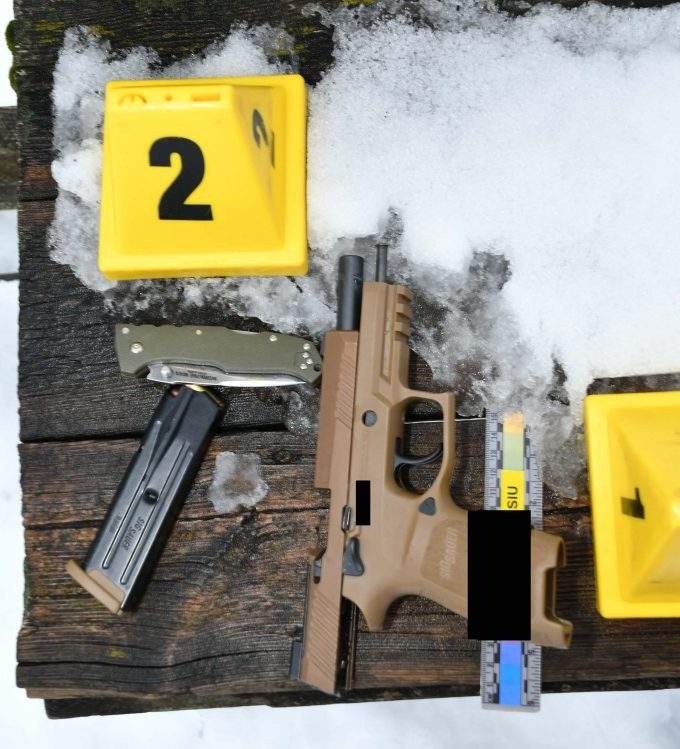 A firearm and knife the SIU says were recovered at at the scene, Feb. 22, 2021. The items were located on a bench on the southern end of the observation deck. (Image edited by the SIU.)