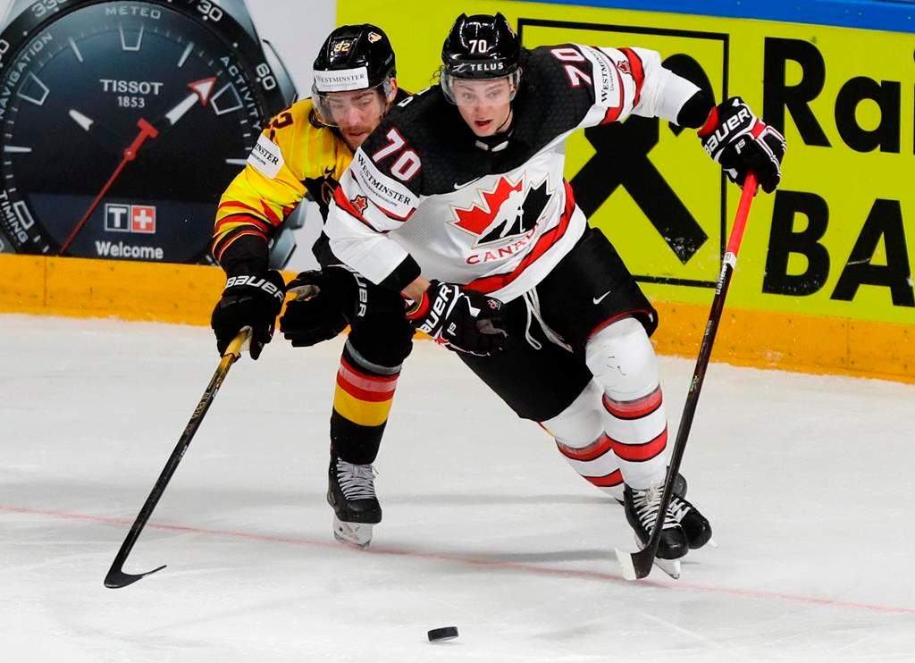Germany's Marcel Noebels, left, challenges for the puck with Canada's Troy Stecher during the Ice Hockey World Championship group B match between Germany and Canada at the Arena in Riga, Latvia, Monday, May 24, 2021.