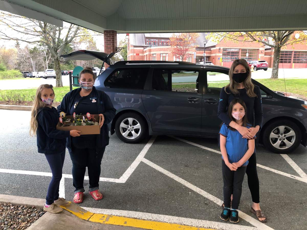 4th Bedford Brownies Peyton Scott (left) and Kayleigh MacDonald deliver teacup planters to the Berkeley retirement home in Bedford, N.S. on May 8, 2021 with their mothers, Girl Guides district commissioner Tanya MacLennan-Scott (left) and unit guider Stephanie MacDonald.