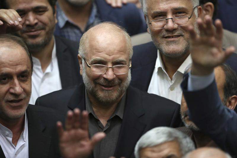 FILE - In this May 28, 2020, file photo, Mohammad Bagher Qalibaf, center, is surrounded by a group of lawmakers after being elected as speaker of the parliament, in Tehran, Iran. Iran's parliament speaker says international inspectors may no longer access images of the Islamic Republic's nuclear sites. 