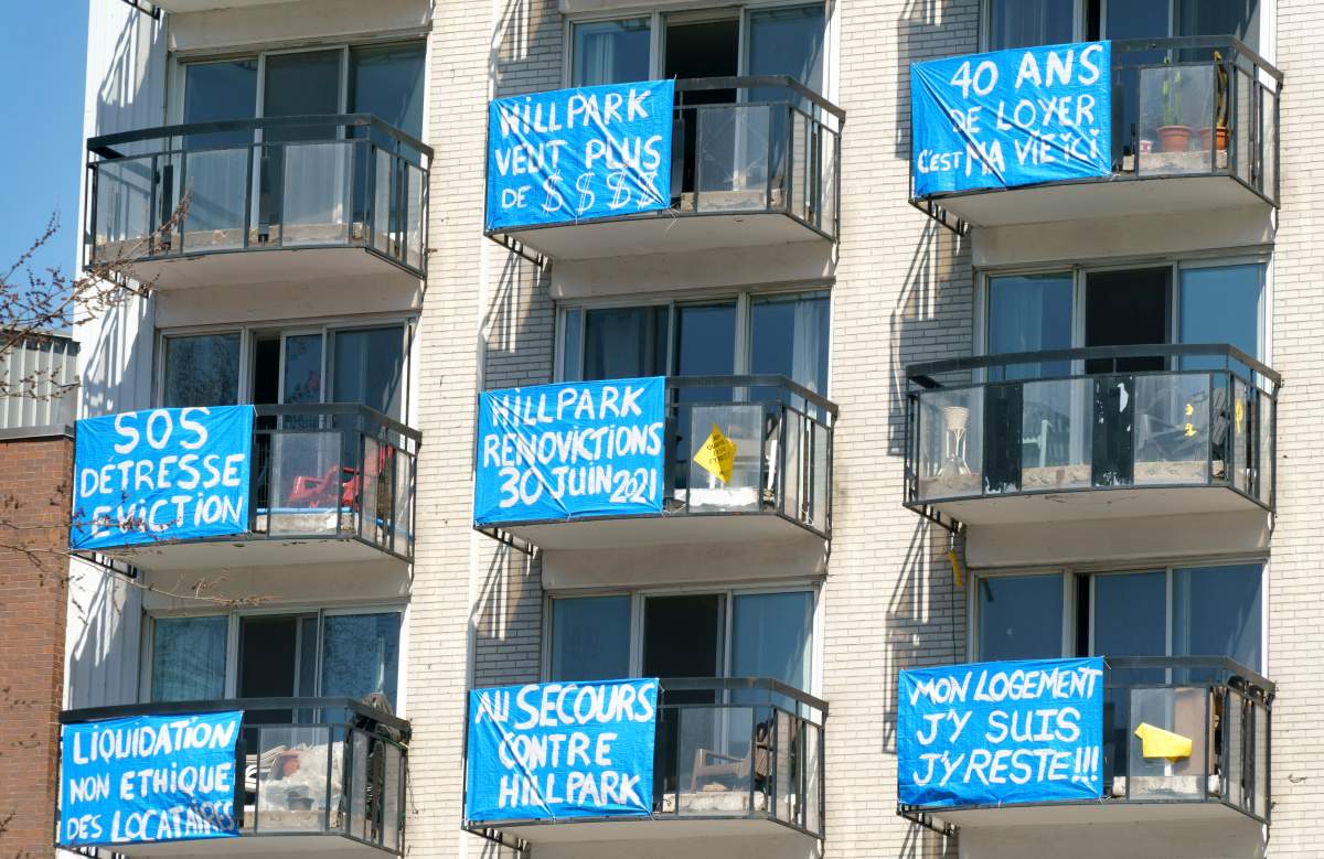 Banners are seen on the balconies of an apartment building where residents recently received notices stating they must move out for at least seven months due to major repairs and renovations in Montreal on Friday, April 9, 2021.