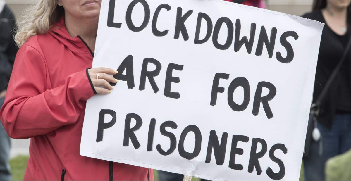 Demonstrators march at a protest against government measures to curb the spread of COVID-19, in Peterborough, Ont., Saturday, April 24, 2021. 