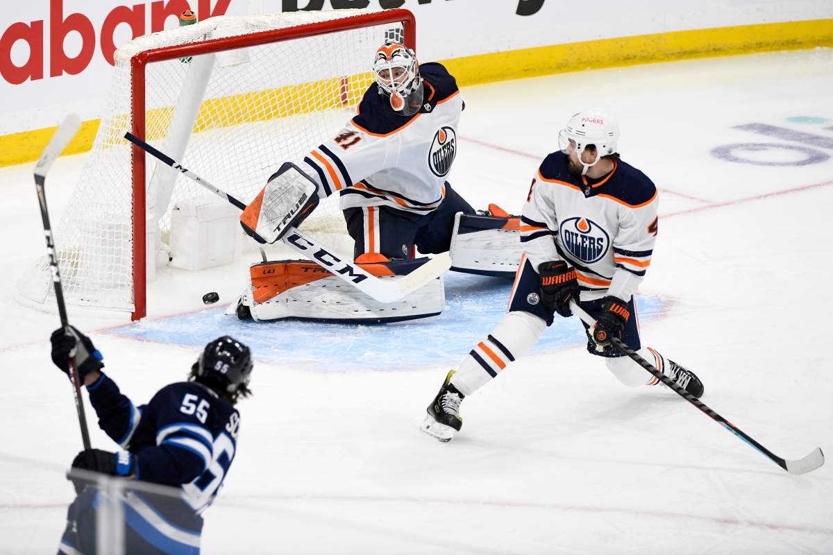 Winnipeg Jets’ Mark Scheifele (55) scores on Edmonton Oilers goaltender Mike Smith (41) during first period NHL Stanley Cup playoff action in Winnipeg on Monday, May 24, 2021. THE CANADIAN PRESS/Fred Greenslade