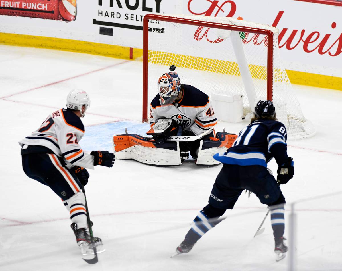 Winnipeg Jets' Kyle Connor (81) scores the game-winning goal on Edmonton Oilers’ goaltender Mike Smith (41) during third overtime period NHL Stanley Cup playoff action in Winnipeg on Monday, May 24, 2021.