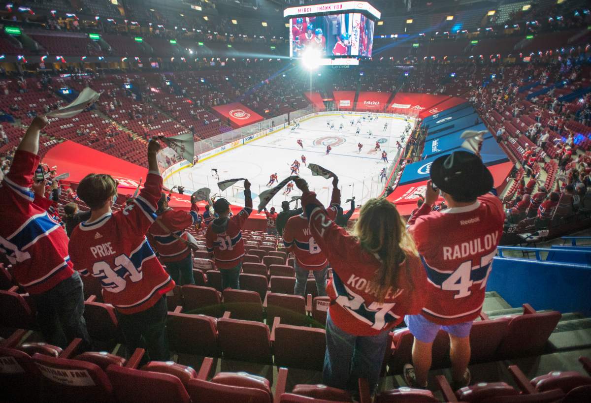 Fans watch the warm-up before Game 6 between the Toronto Maple Leafs and the Montreal Canadiens in NHL playoff hockey action Saturday, May 29, 2021 in Montreal. Quebec's easing of COVID-19 restrictions will allow 2,500 fans to attend the game for the first time in fourteen months. 