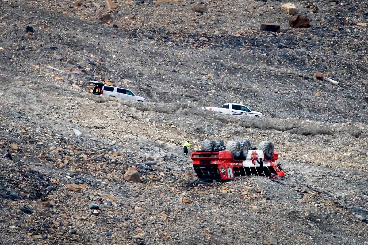 RCMP work on the scene of a sightseeing bus rollover on the Columbia Icefield near Jasper, Alta., Sunday, July 19, 2020. Three people were killed and more than a dozen others were critically injured when a glacier sightseeing bus rolled at one of the most popular attractions in the Rocky Mountains, the Columbia Icefield, on Saturday, July 18, 2020.