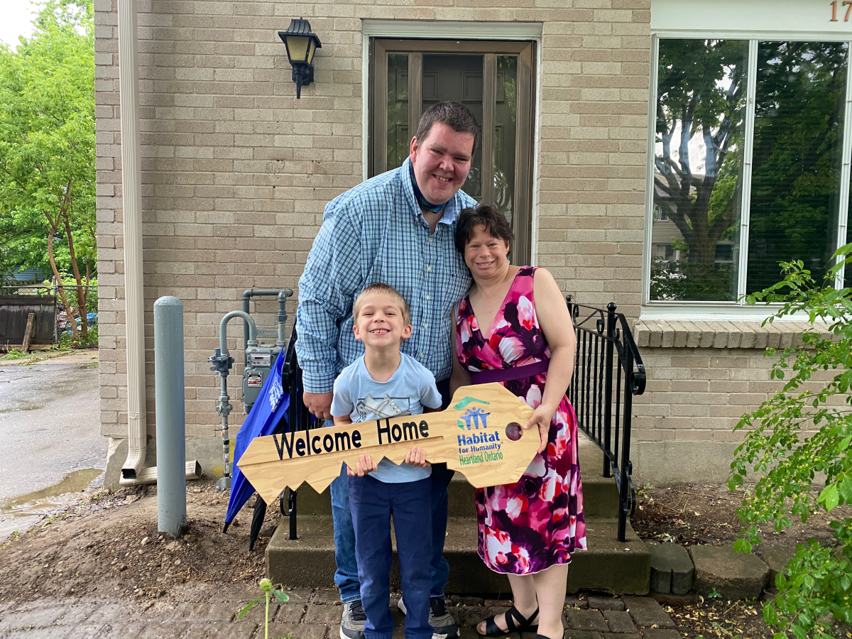 Jamie, Jennifer and their son Christopher stand in front of their new home on Culver Drive ahead of a virtual ceremony on Wednesday.