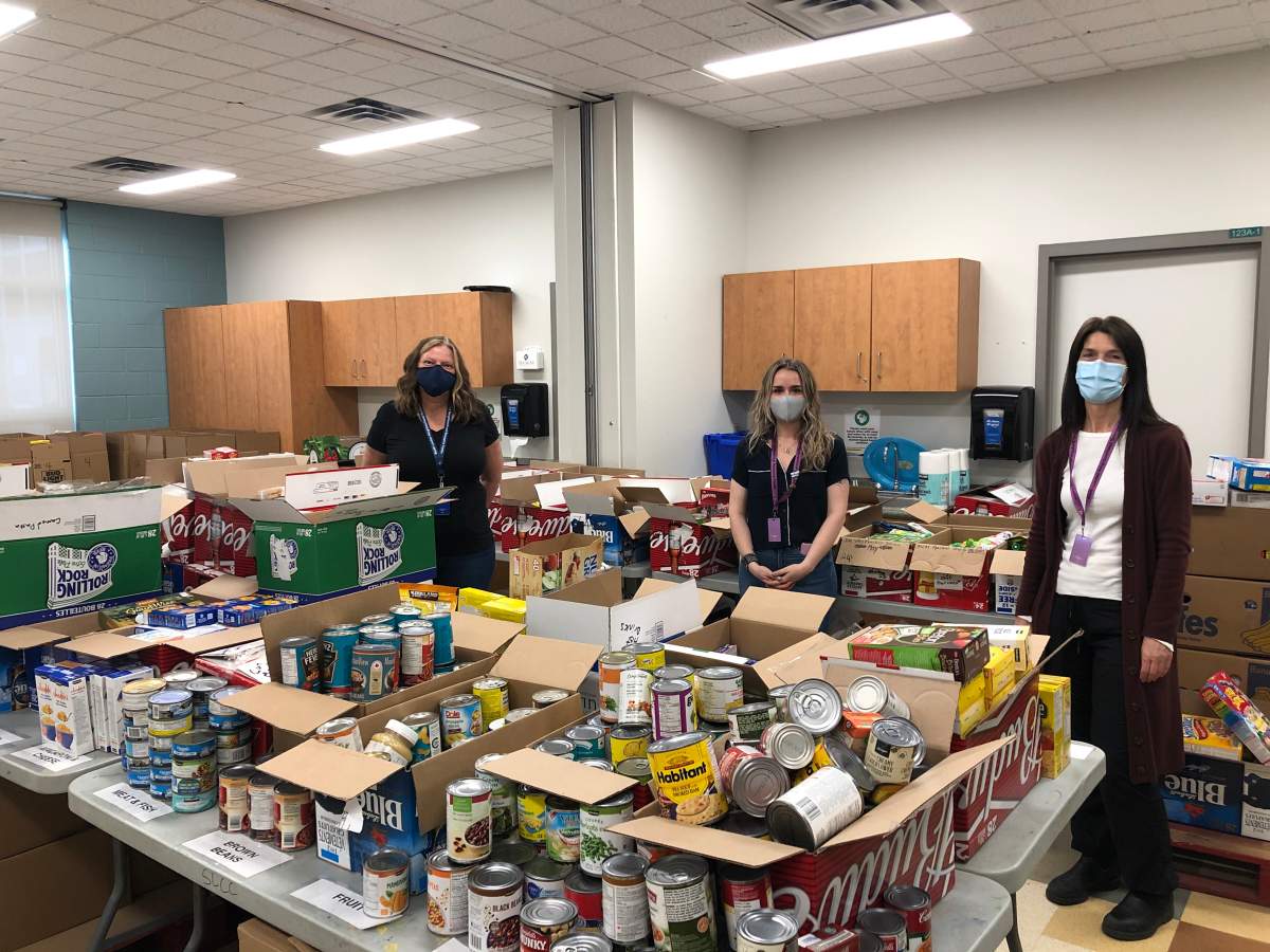 South London Neighbourhood Resource Centre executive director Nancy Needham (left) and fellow staff members Pascale Cantin (centre) and Heather Molen stand alongside a shipment of food reserved for those in need.