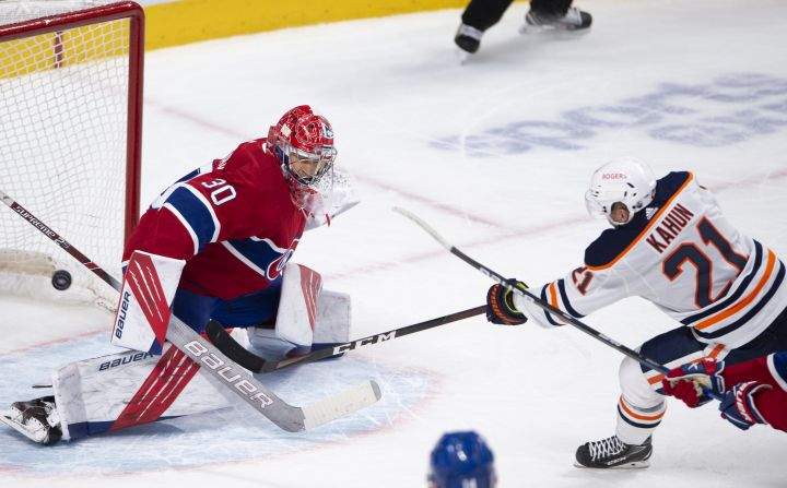 Edmonton Oilers’ Dominik Kahun (21) scores the winning goal on Montreal Canadiens goaltender Cayden Primeau (30) during overtime NHL hockey action Wednesday, May 12, 2021 in Montreal.