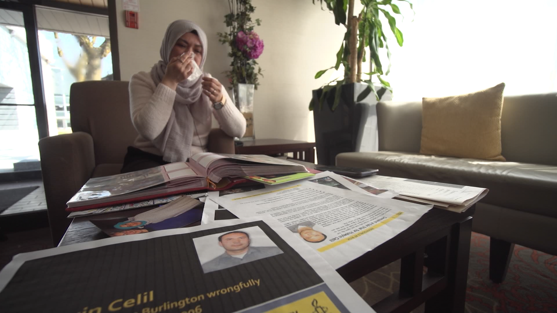 Kamila Telendibaeva looks through family photographs and documents near her home in Burlington, Ont. Her husband, Huseyin Celil, is detained in China.