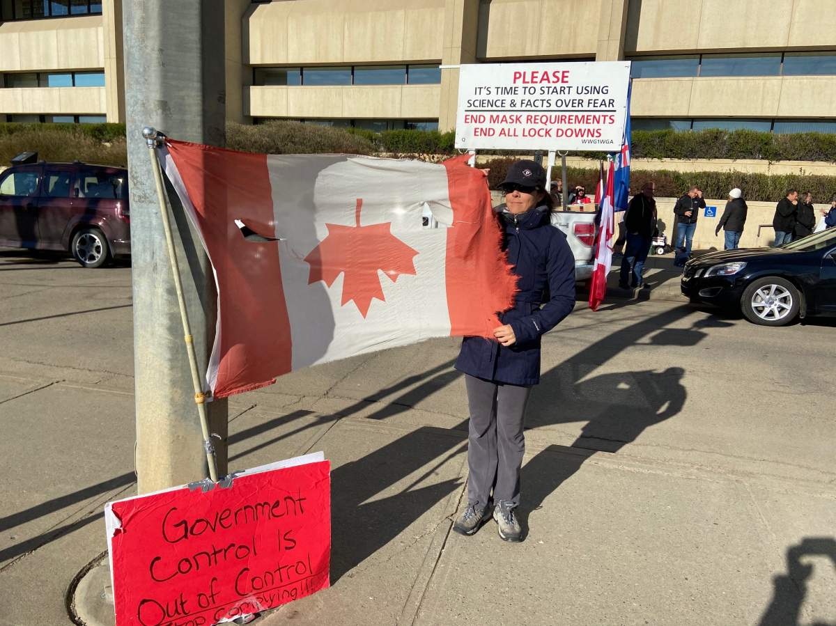People rally outside the courthouse in Edmonton in support of pastor James Coates of GraceLife Church whose trial began Monday, May 3, 2021.