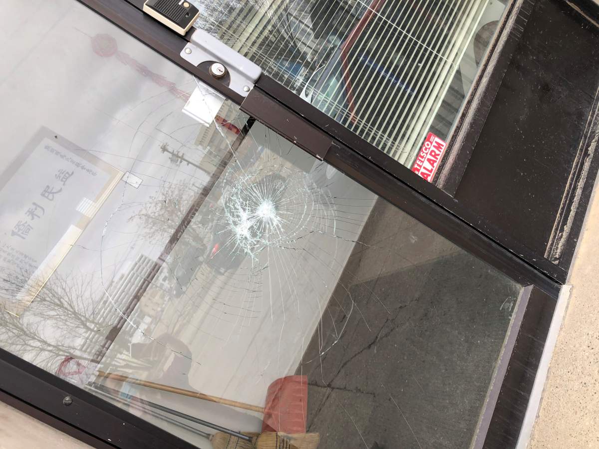 A damaged door at Edmonton Chinese Benevolent Association building.
