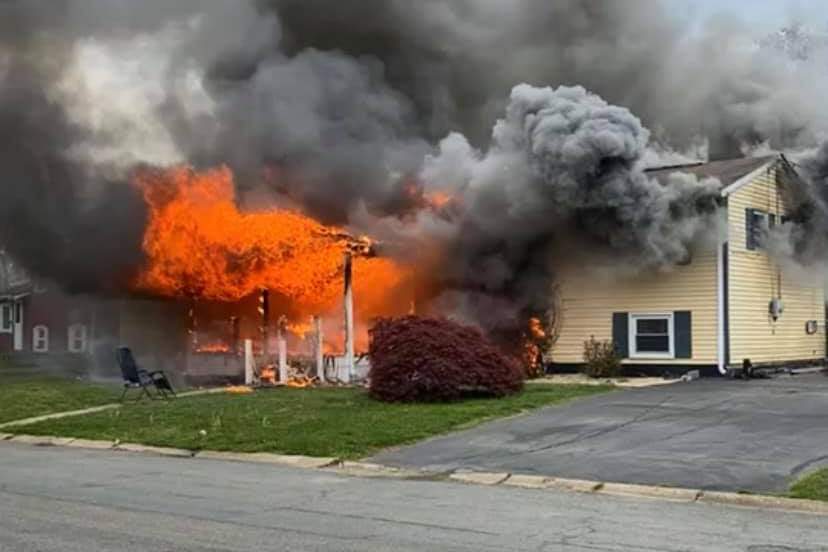 A lawn chair sits in front of a burning home in Elkton, Md., on April 29, 2021.