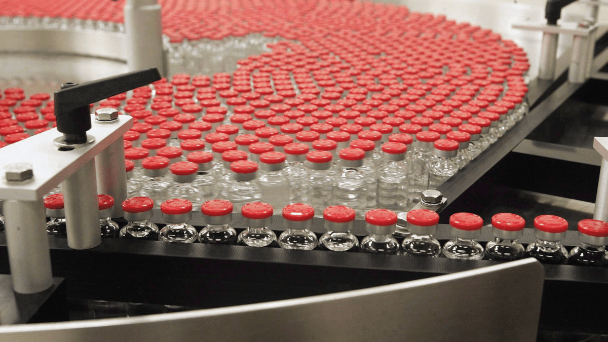 Bottles of flu vaccine rotate on a plate as they make their way through the assembly line at the ID Biomedical Corp. Quebec City plant.