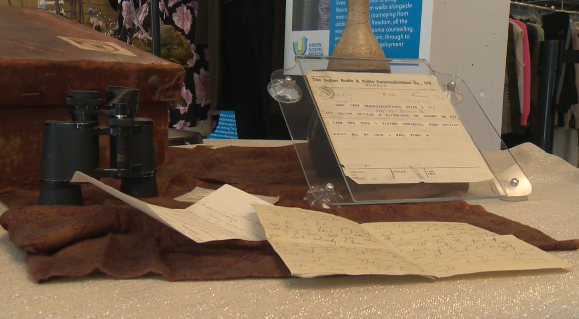 A suitcase, letters, and a cable that appears to have been sent on VE Day displayed at the Union Gospel Mission in Vancouver. 