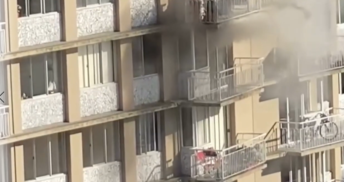 Smoke pours from an 11th-floor unit in a West End apartment Saturday evening.