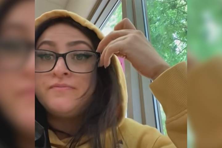 A woman is shown eating lunch while disguised as her daughter in this image from YouTube.