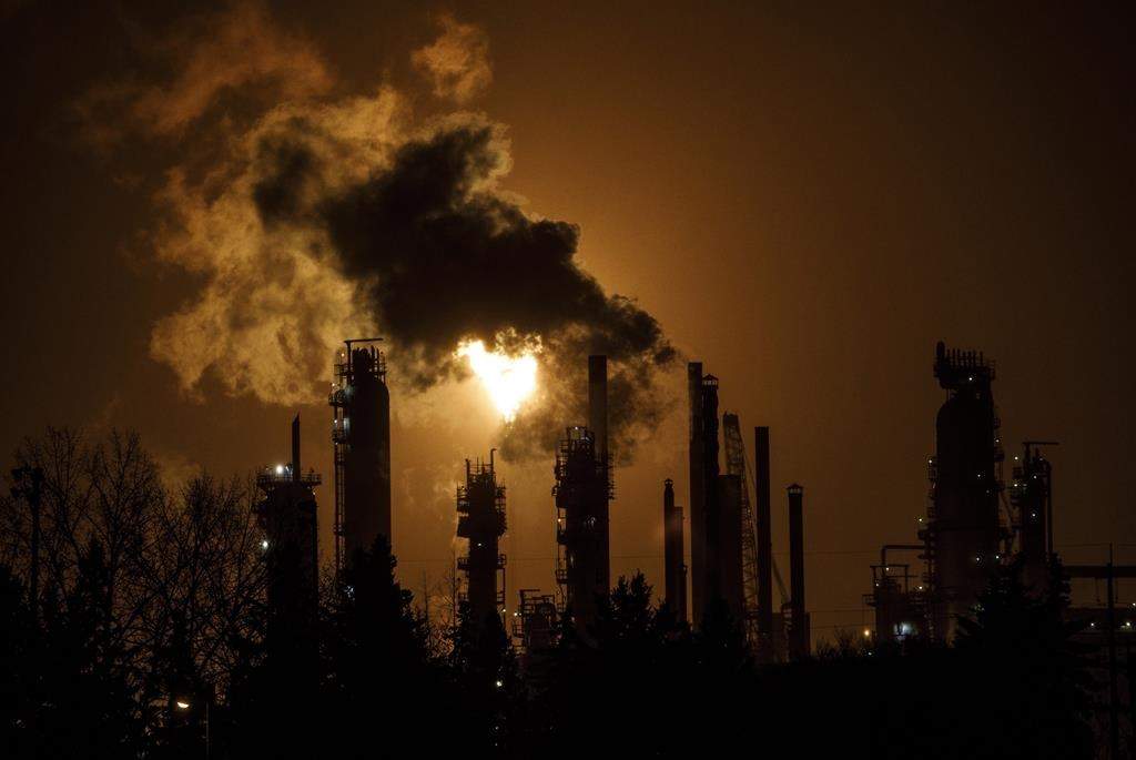 A flare stack lights the sky from oil refinery in Alberta on December 28, 2018.