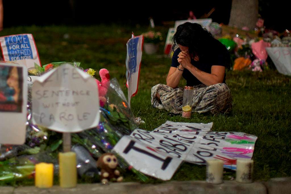 A woman sits and weeps at the scene of Sunday's hate-motivated vehicle attack in London, Ont. on Tuesday, June 8, 2021. Four members of a family in London, Ont., are set to be buried today. The public has been invited to help celebrate the lives of Talat Afzaal, 74, her son Salman Afzaal, 46, his wife Madiha Salman, 44, and their 15-year-old daughter Yumna Salman.THE CANADIAN PRESS/ Geoff Robins.