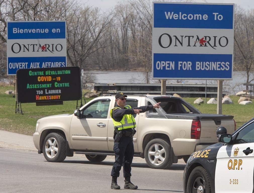 Ontario Provincial Police check travellers entering Ontario from Quebec as new COVID-19 measures take effect in Hawkesbury, Ont., on April 19, 2021. THE CANADIAN PRESS/Ryan Remiorz.