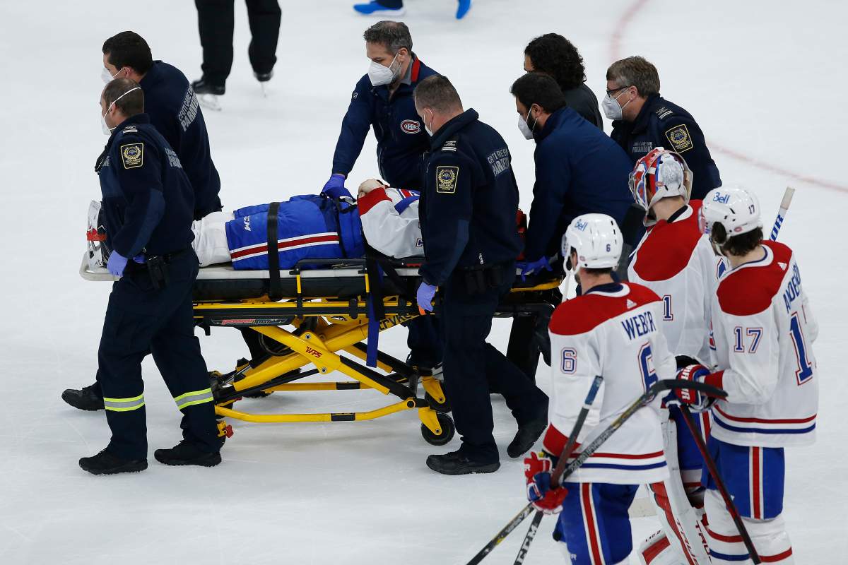 Montreal Canadiens’ Jake Evans (71) is taken off the ice on a stretcher after getting hit by Winnipeg Jets’ Mark Scheifele (55) during third period NHL Stanley Cup hockey action in Winnipeg, Wednesday, June 2, 2021.