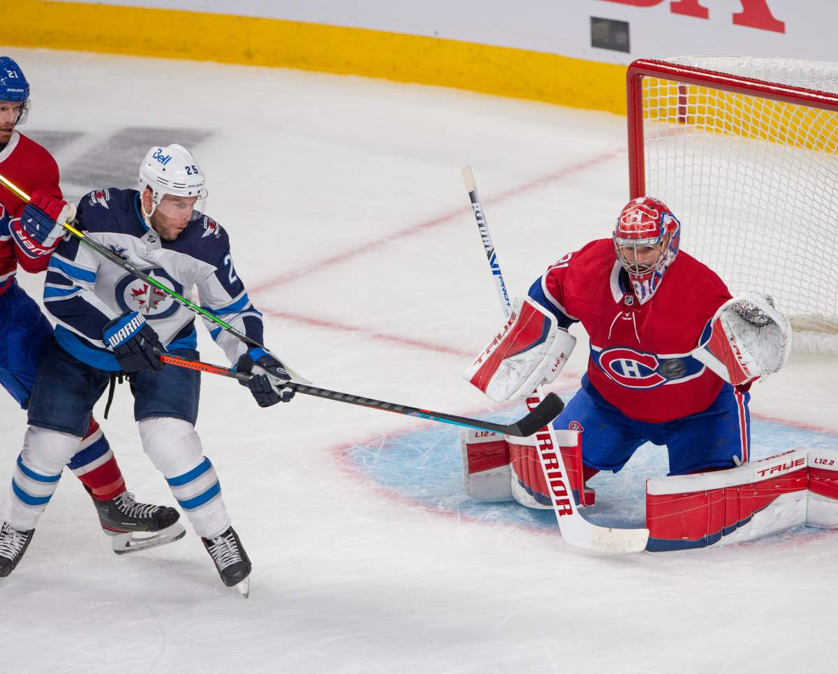 Montreal Canadiens goaltender Carey Price (31) keeps his eye on the puck as he stops the Winnipeg Jets’ Paul Stastny (25) during first-period NHL Stanley Cup playoff hockey action in Montreal, Sunday, June 6, 2021.