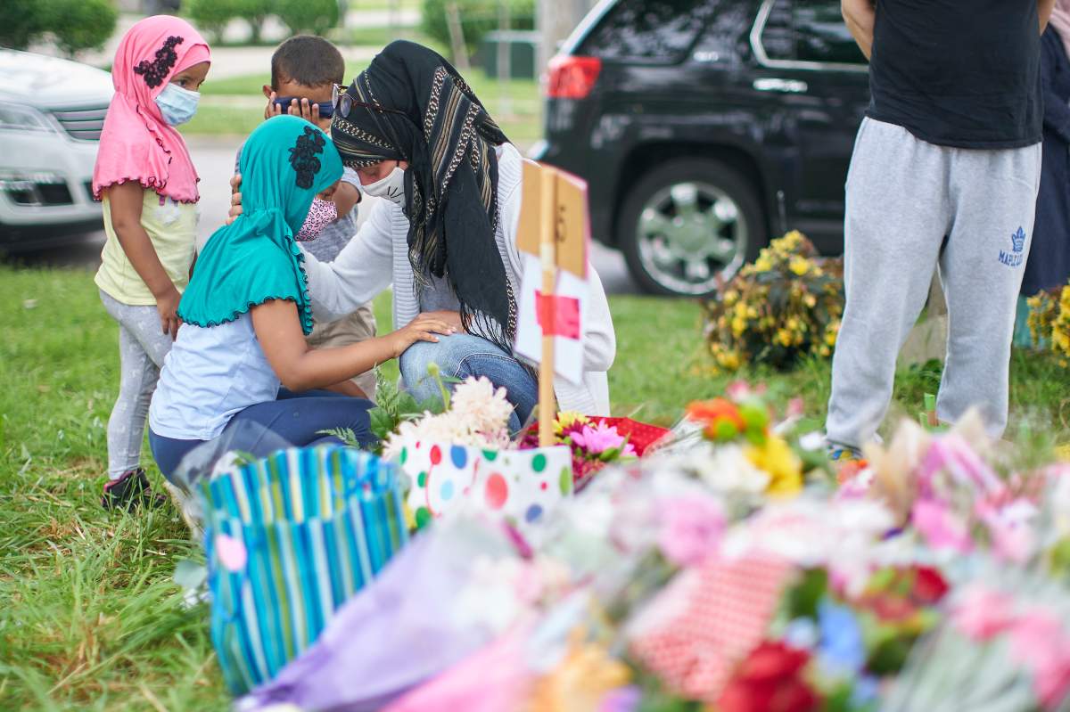 Kira Stephani of Oshawa, Ont., talks with her daughter Aisha Sayyed on Tuesday, June 8, 2021 at the scene of Sunday's hate-motivated vehicle attack in London, Ont., which left four members of a Muslim family dead and sent their youngest boy to hospital.