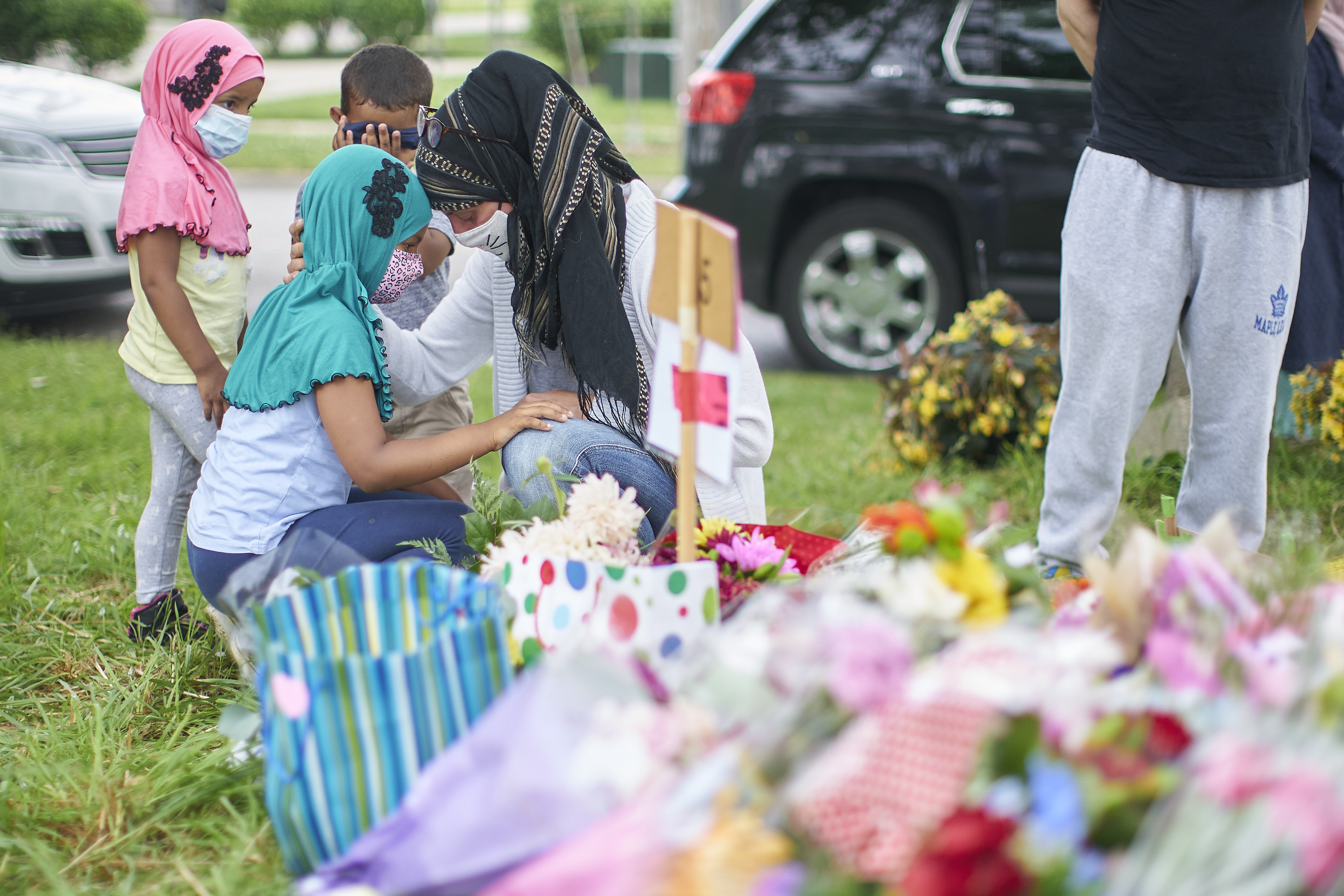 Kira Stephani of Oshawa, Ont. talks with her daughter Aisha Sayyed at the scene of a hate-motivated vehicle attack in London, Ont. THE CANADIAN PRESS/ Geoff Robins
