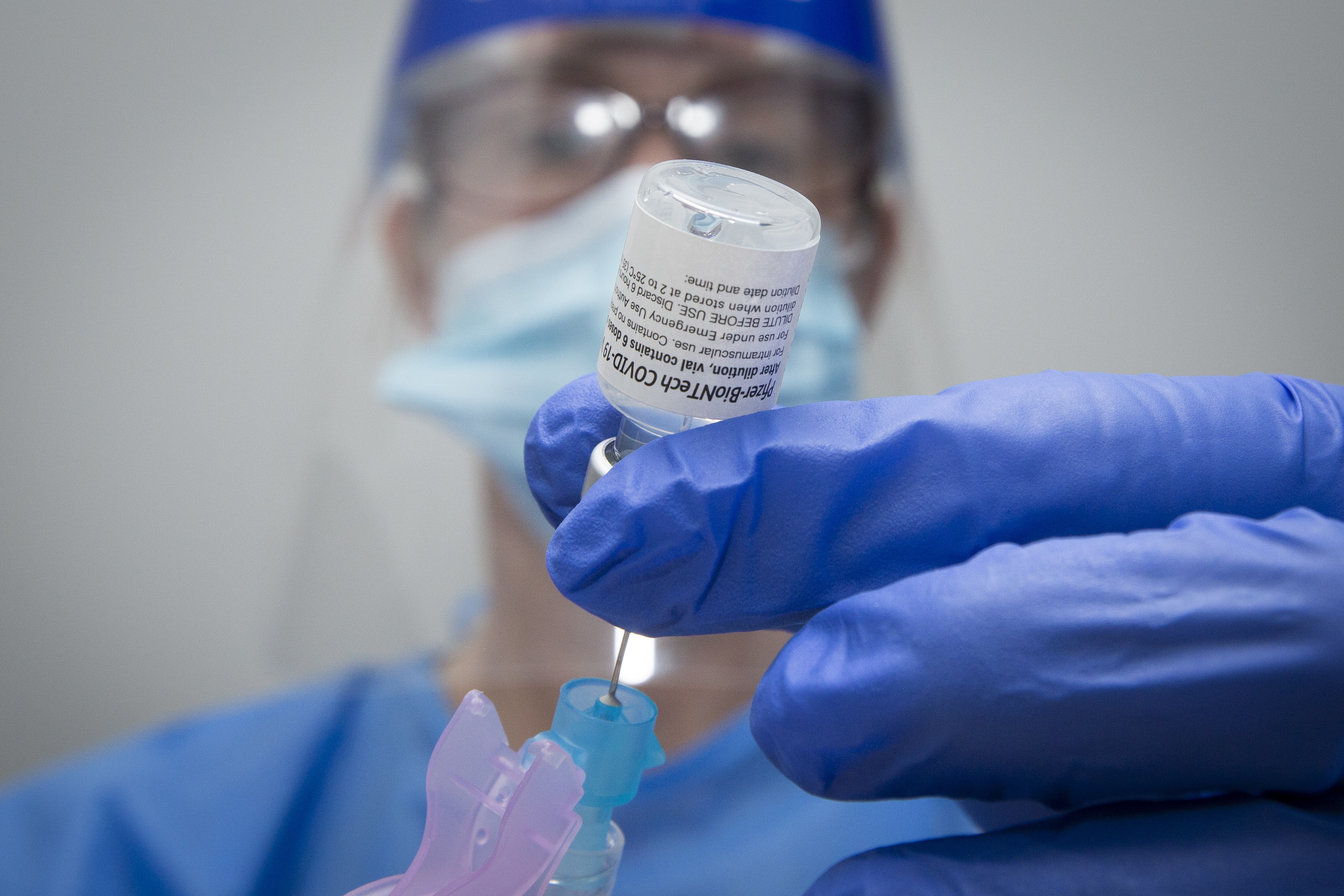 Pharmacist Suzanne Garrett draws a syringe with Pfizer-BioNTech covid-19 vaccine at a pharmacy in Amherstview, Ontario on Friday June 25, 2021. THE CANADIAN PRESS IMAGES/Lars Hagberg.