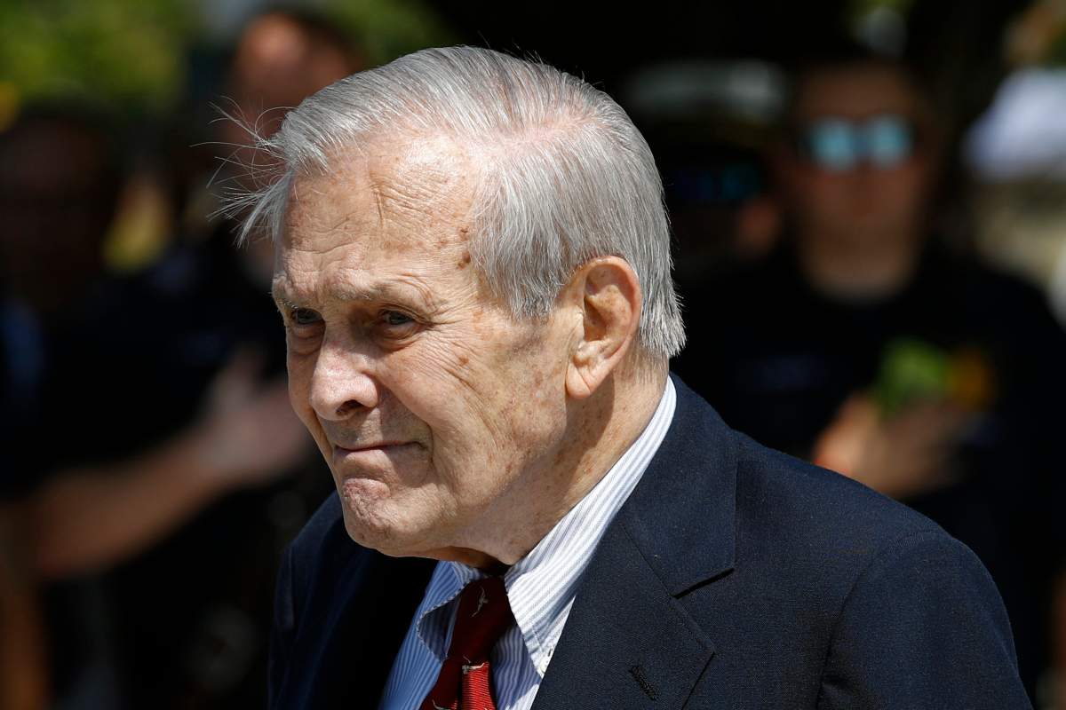 FILE - In this Sept. 11, 2019, file photo, former Defense Secretary Donald Rumsfeld attends a wreath laying ceremony with former President George W. Bush and Defense Secretary Mark Esper on the grounds of the National 9/11 Pentagon Memorial at the Pentagon.