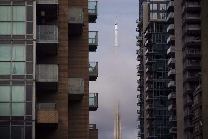 The CN Tower can be seen behind condos in Toronto’s Liberty Village community in Toronto on Tuesday, April 25, 2017.