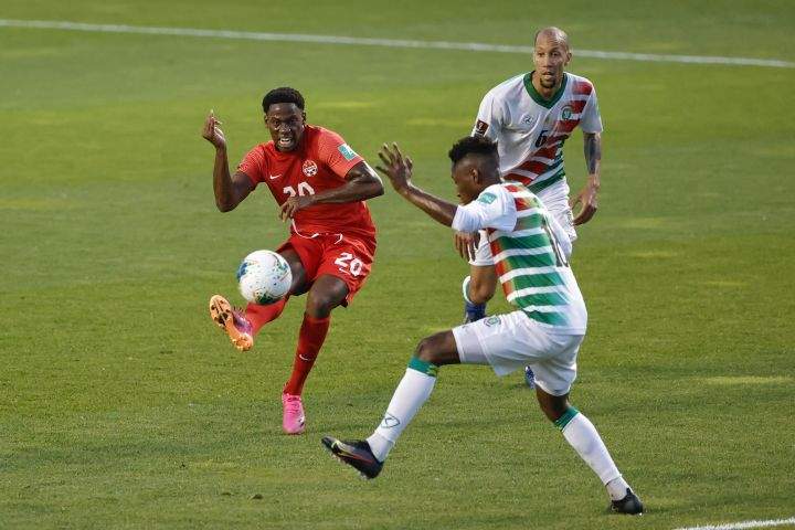 Canada’s Jonathan David (20) tries to score past Suriname’s Kelvin Leerdam (18) during the first half of a World Cup 2022 Group B qualifying soccer match Tuesday, June 8, 2021, in Bridgeview, Ill.