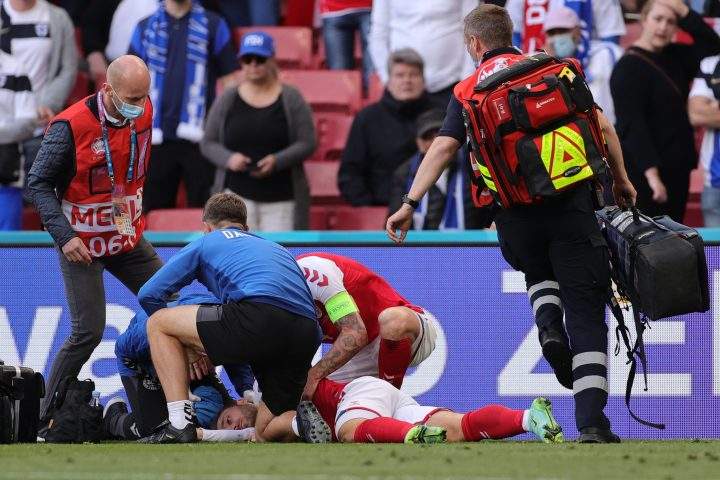 Eriksen receives medical attention after collapsing on the pitch on June 12, 2021