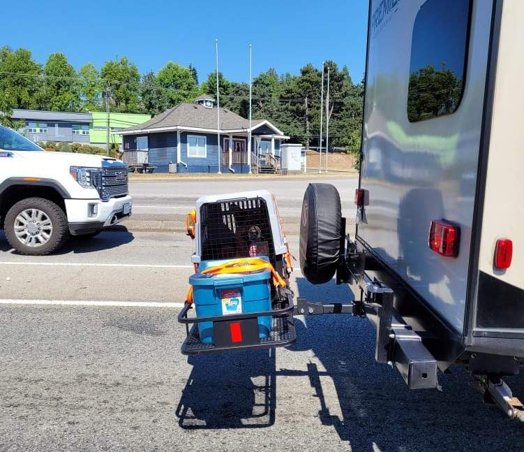 Heather Peters says she snapped this photo of a crated dog in heat distress strapped to the back of a travelling RV on Sunday afternoon.