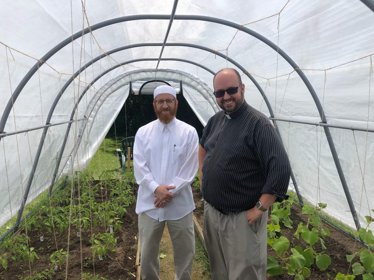 Imam Abd Alfatah Twakkal (left) of the London Muslim Mosque and Canon Kevin George stand inside Abraham’s Tent at St. Aidan’s Anglican Church.