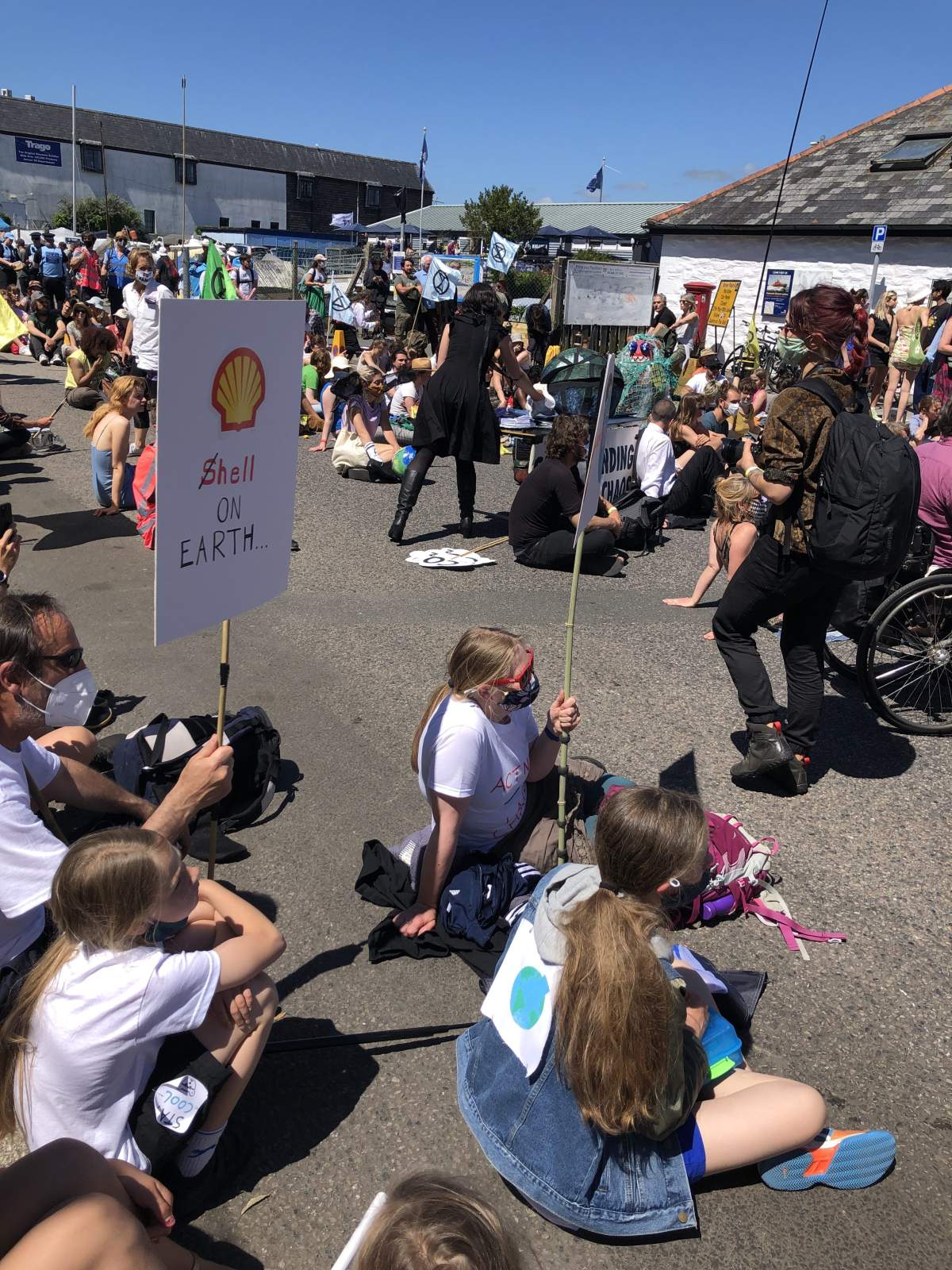 Protesters gathered outside the media centre at the G7 in Falmouth, England.